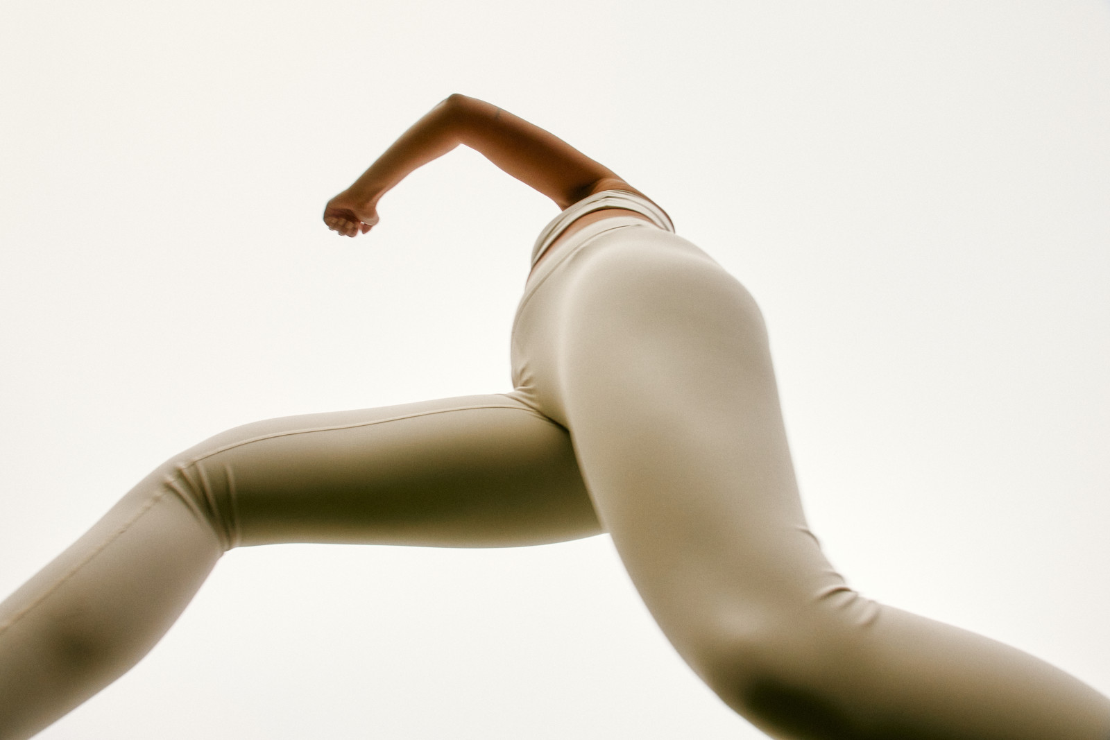 Close-up of a Pilates movement in soft, neutral-toned activewear